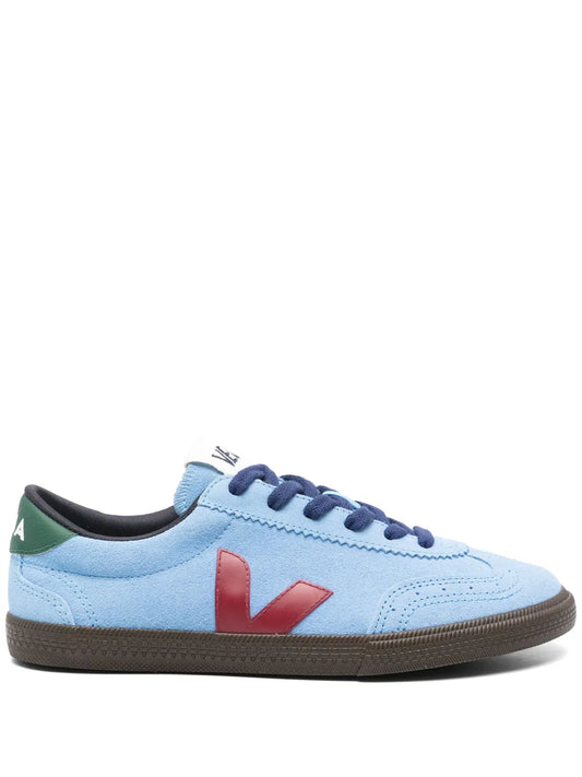 Light blue low-top sneaker with red V logo, navy laces, brown rubber sole