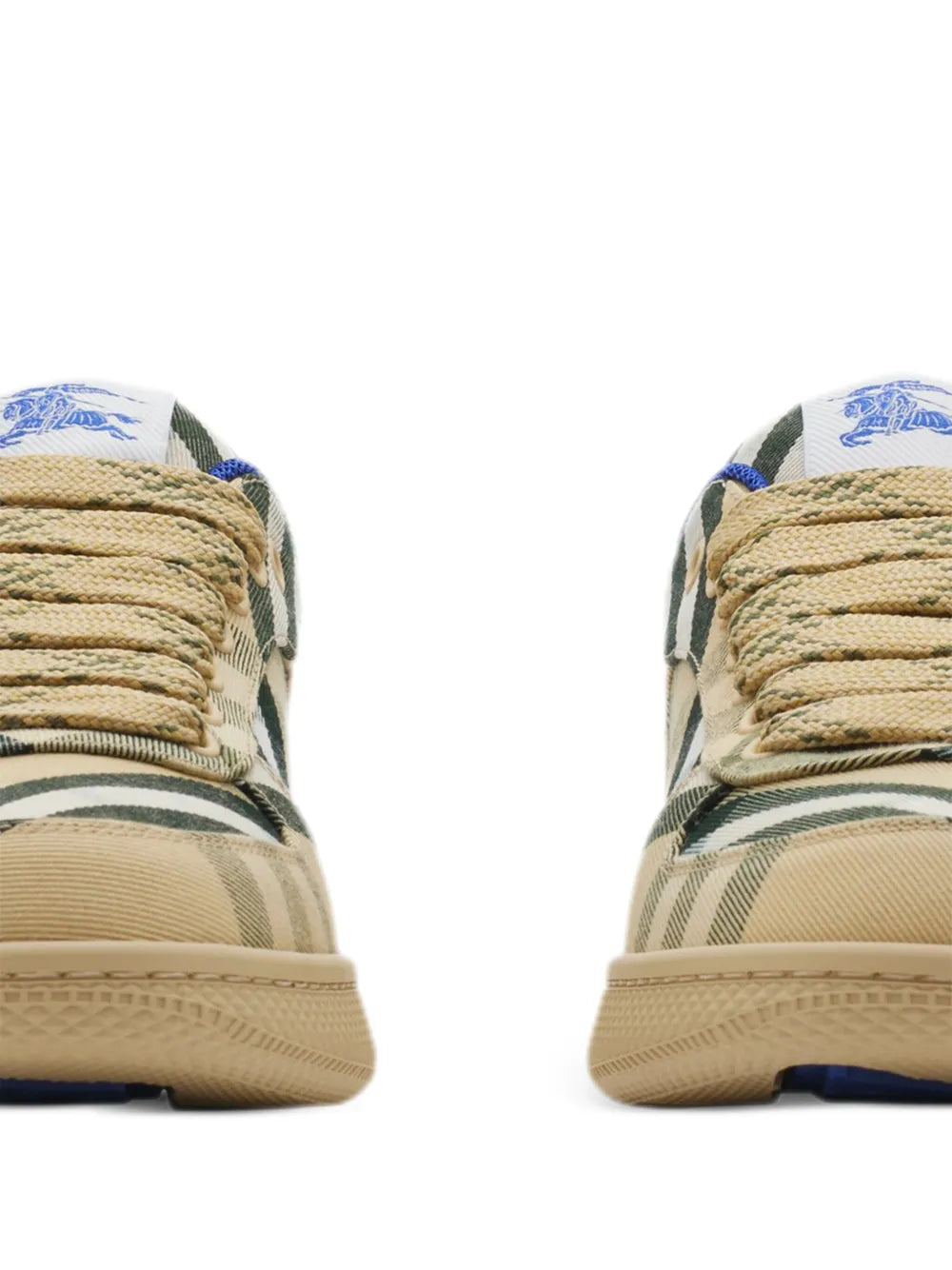 Side view of beige low-top sneakers with green/black plaid panels and blue accents