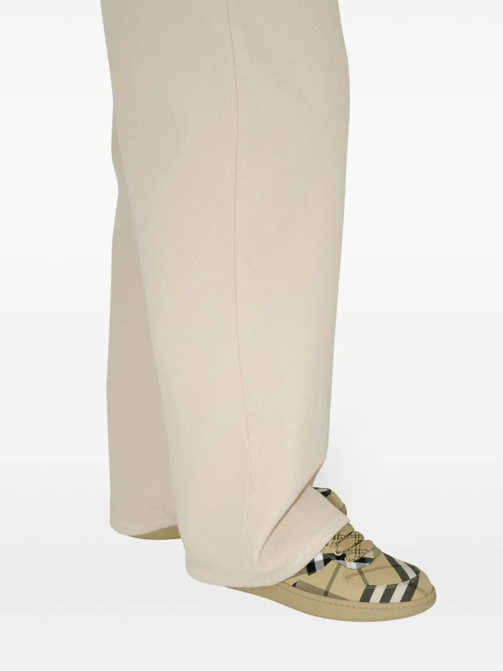 Beige low-top sneakers with green/black plaid upper and blue collar