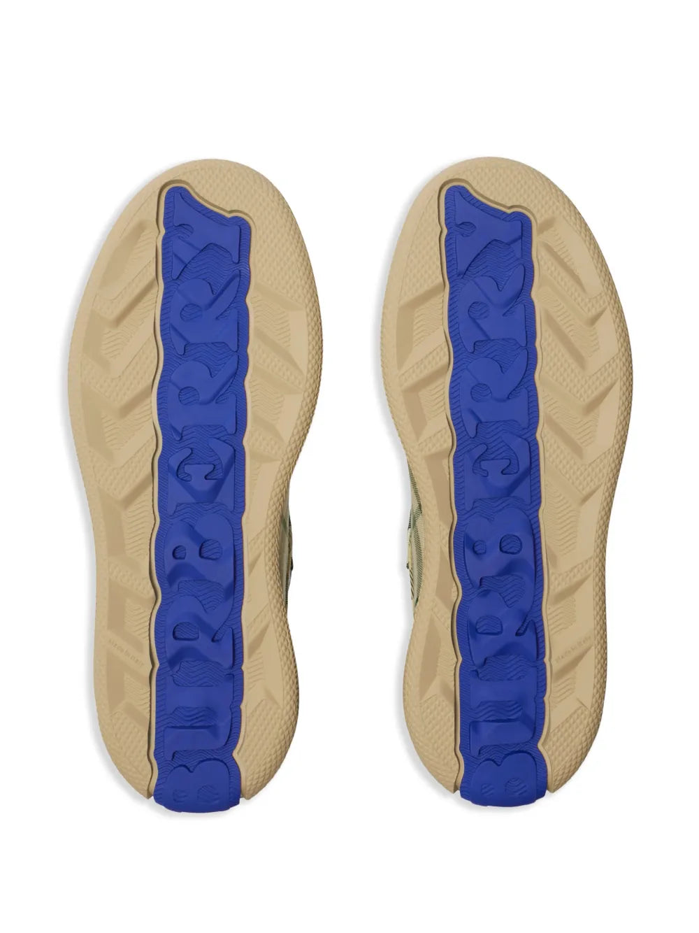 Beige sneaker soles with raised tread and blue logo detail