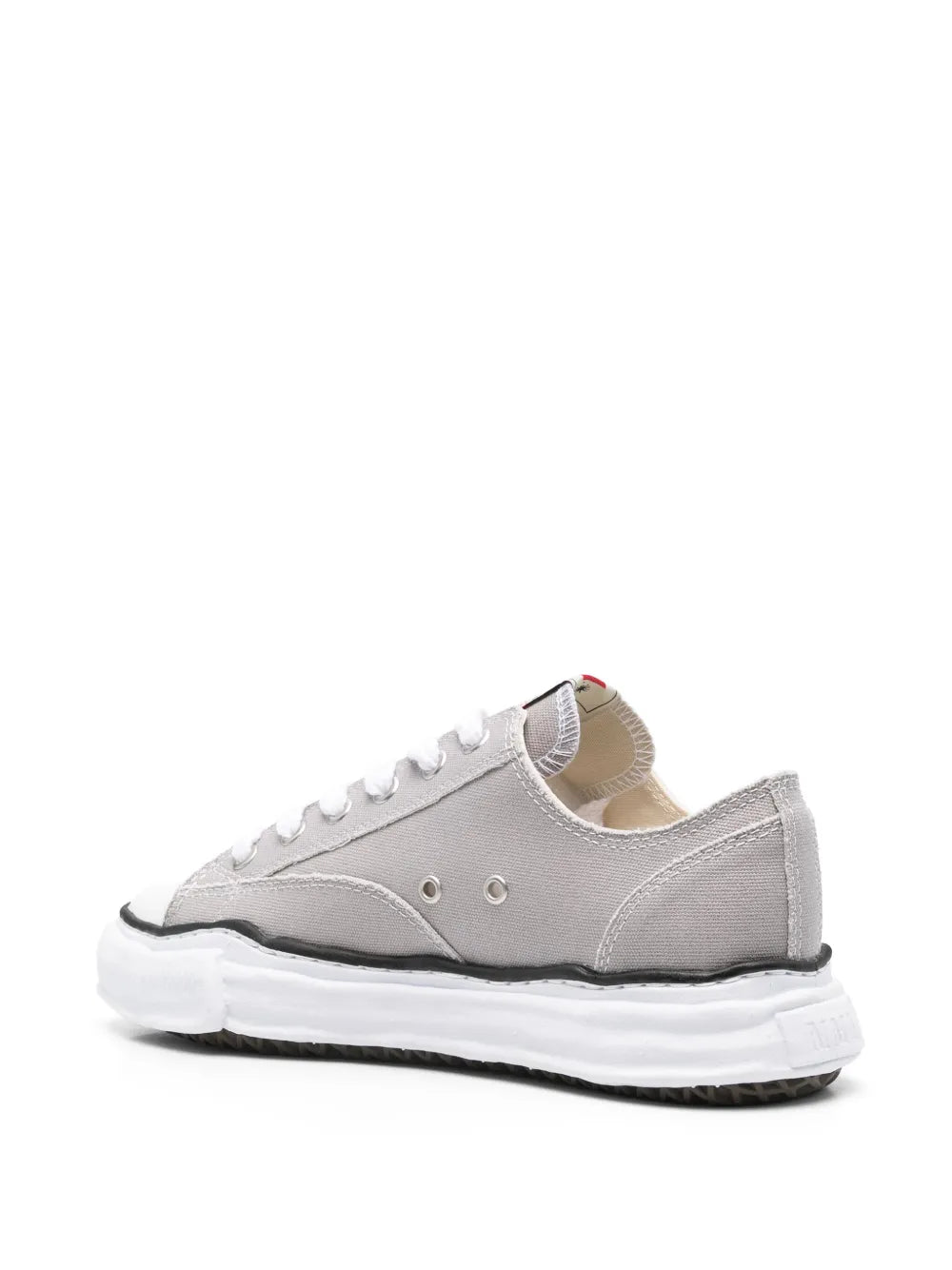 Light grey low-top sneakers with white laces and chunky rubber sole, angled side