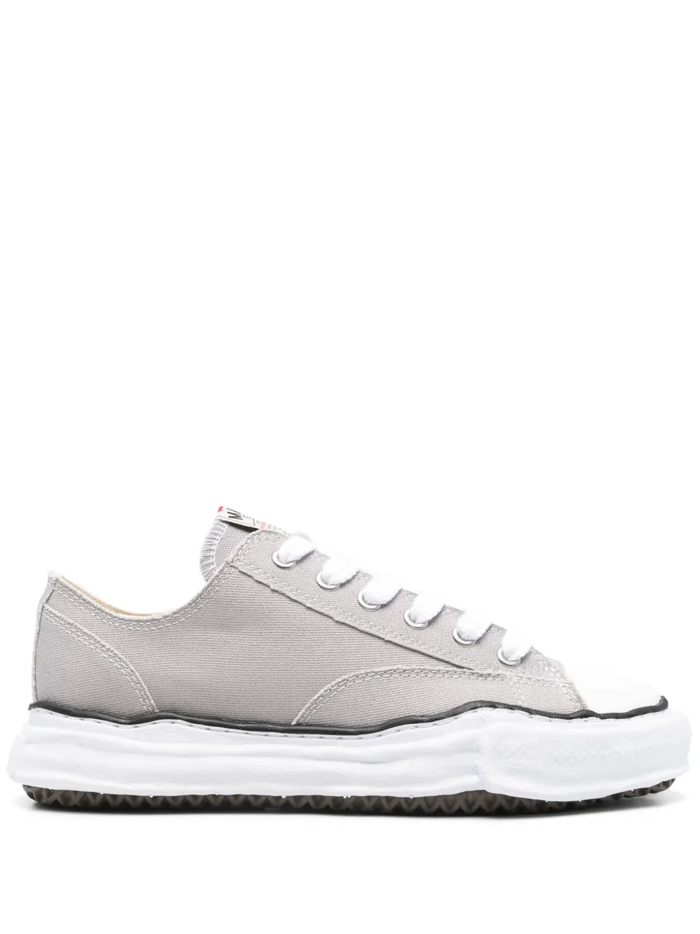 Light grey low-top sneakers with white laces and chunky rubber sole