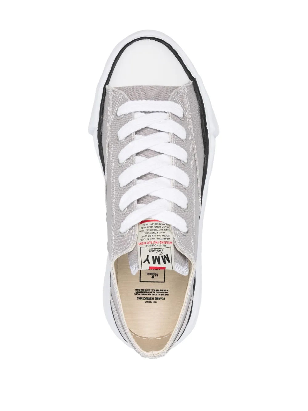 Light grey low-top sneakers with white laces and tongue lining, inside label visible