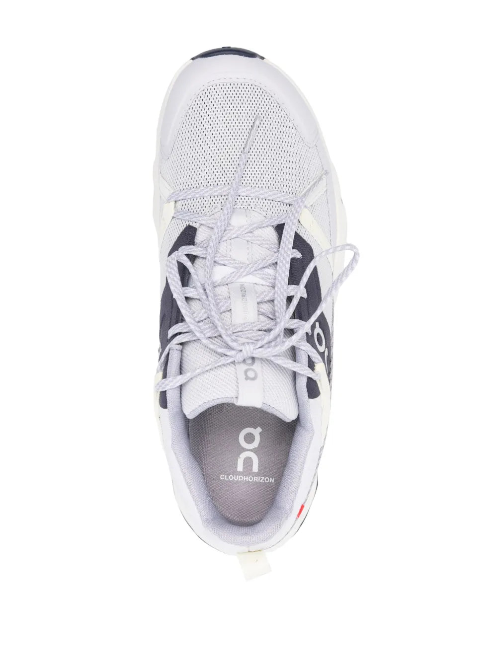 White lace-up running shoe with gray interior padding and On logo on tongue