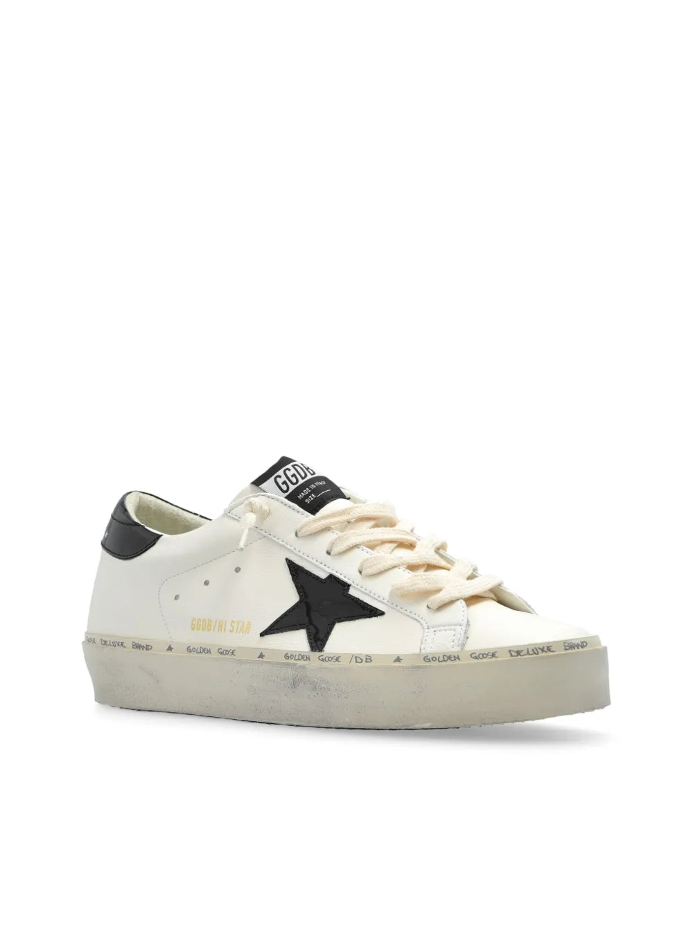 White low-top sneakers with black heel cap and star logo detail