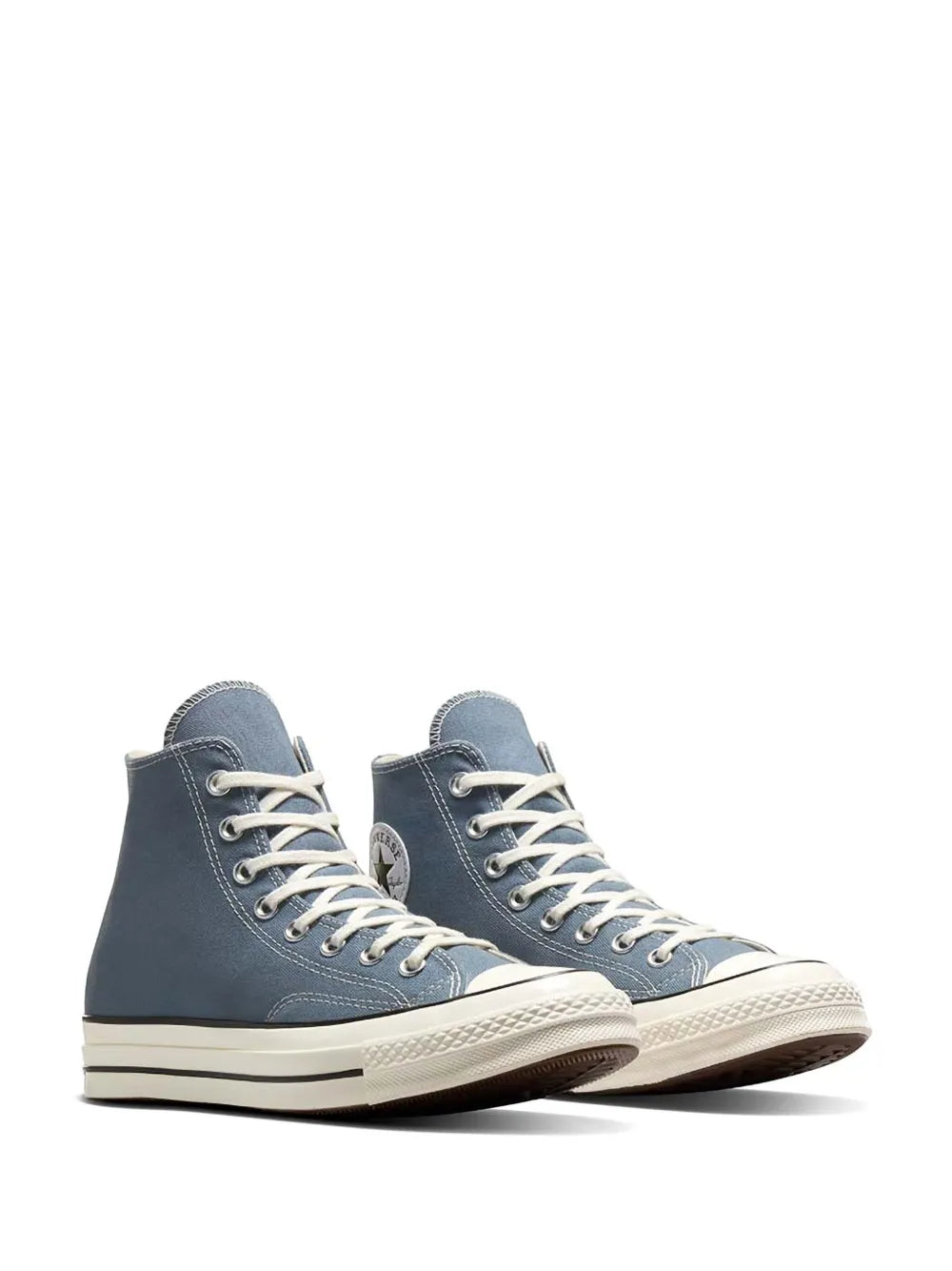 Blue high-top sneakers with white laces and rubber toe cap, side view