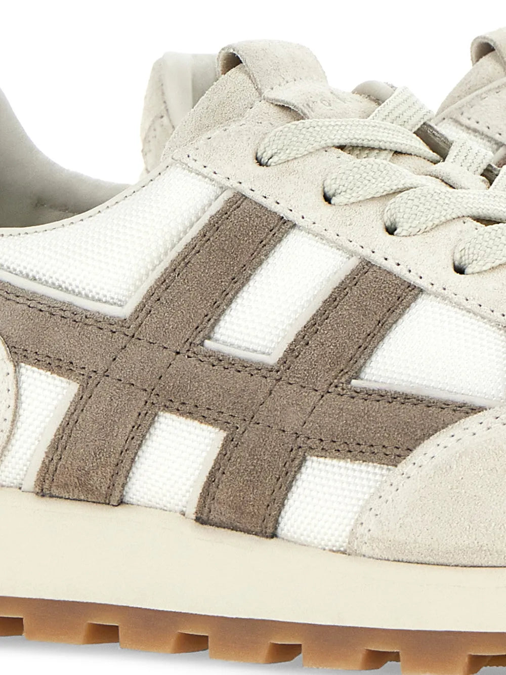 Hogan H671 sneakers close-up: off-white fabric with taupe suede overlays and lace-up eyelets