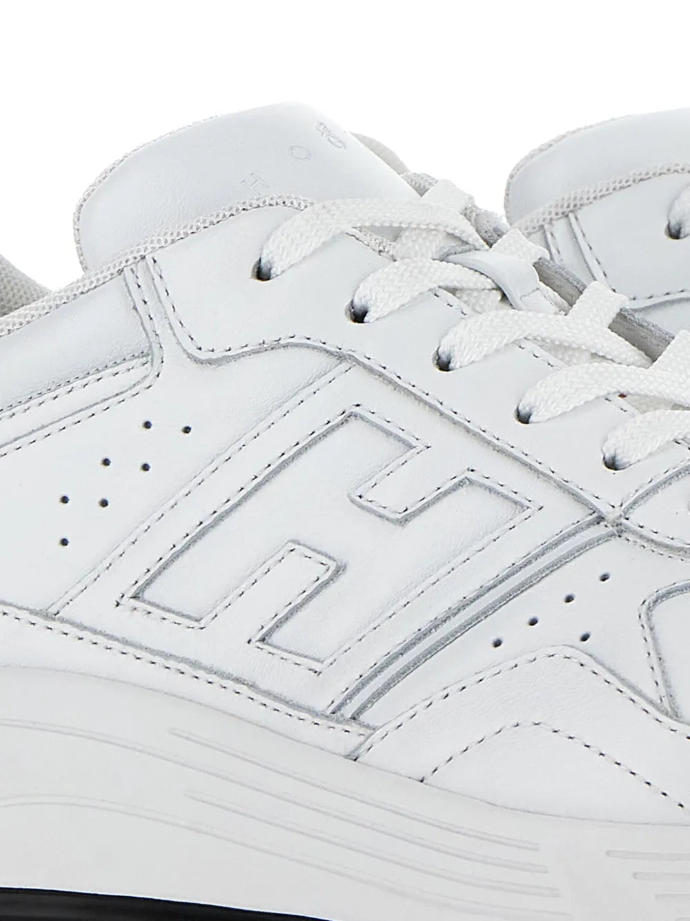 White Hogan Hyperlight sneaker upper close-up with stitched panels and lace eyelets