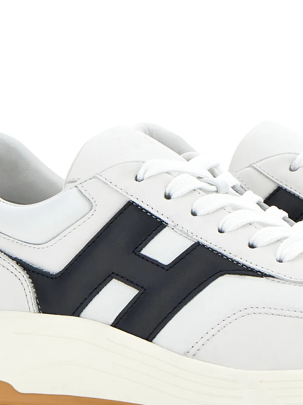 White leather sneakers with black H logo panel and white lace-up