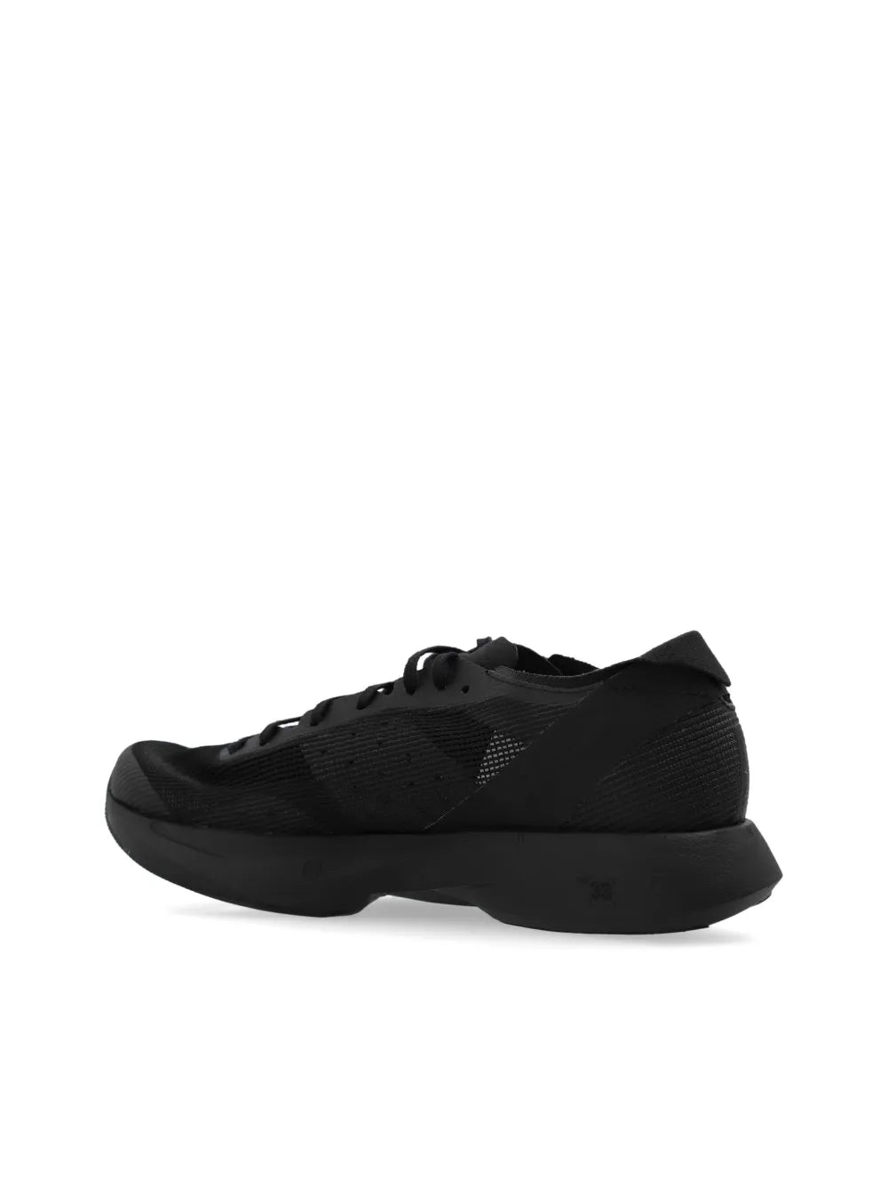 Black low-top lace-up sneaker with textured upper and thick dark outsole