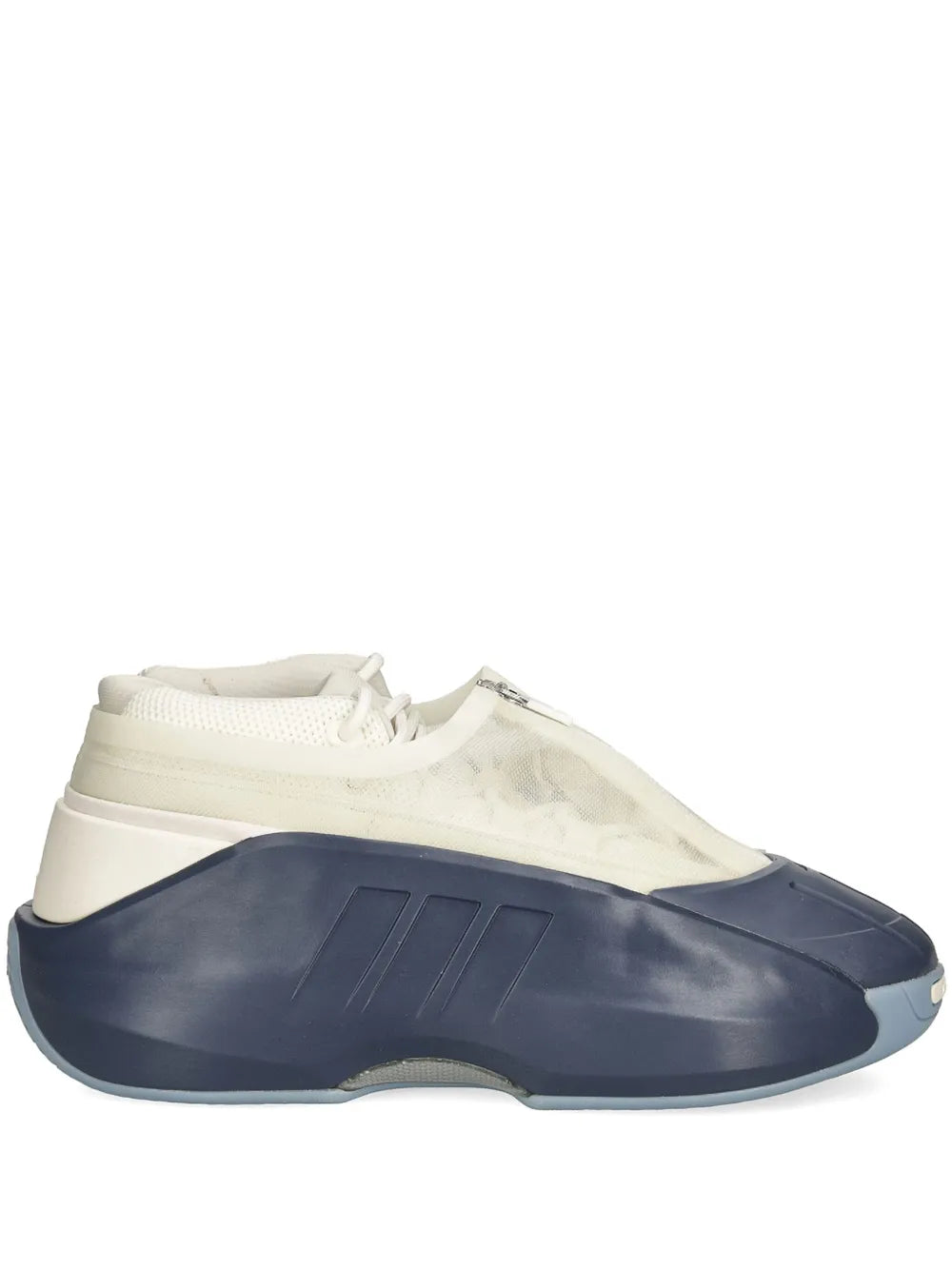 White low-top sneaker with navy toe and side, zip detail, rubber sole