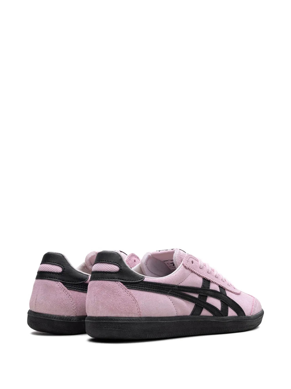 Pair of pink suede low-top sneakers with black heel tabs and side stripes