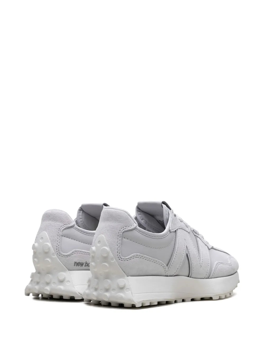Grey sneakers with rear heel tab, cushioned collar, and studded sole