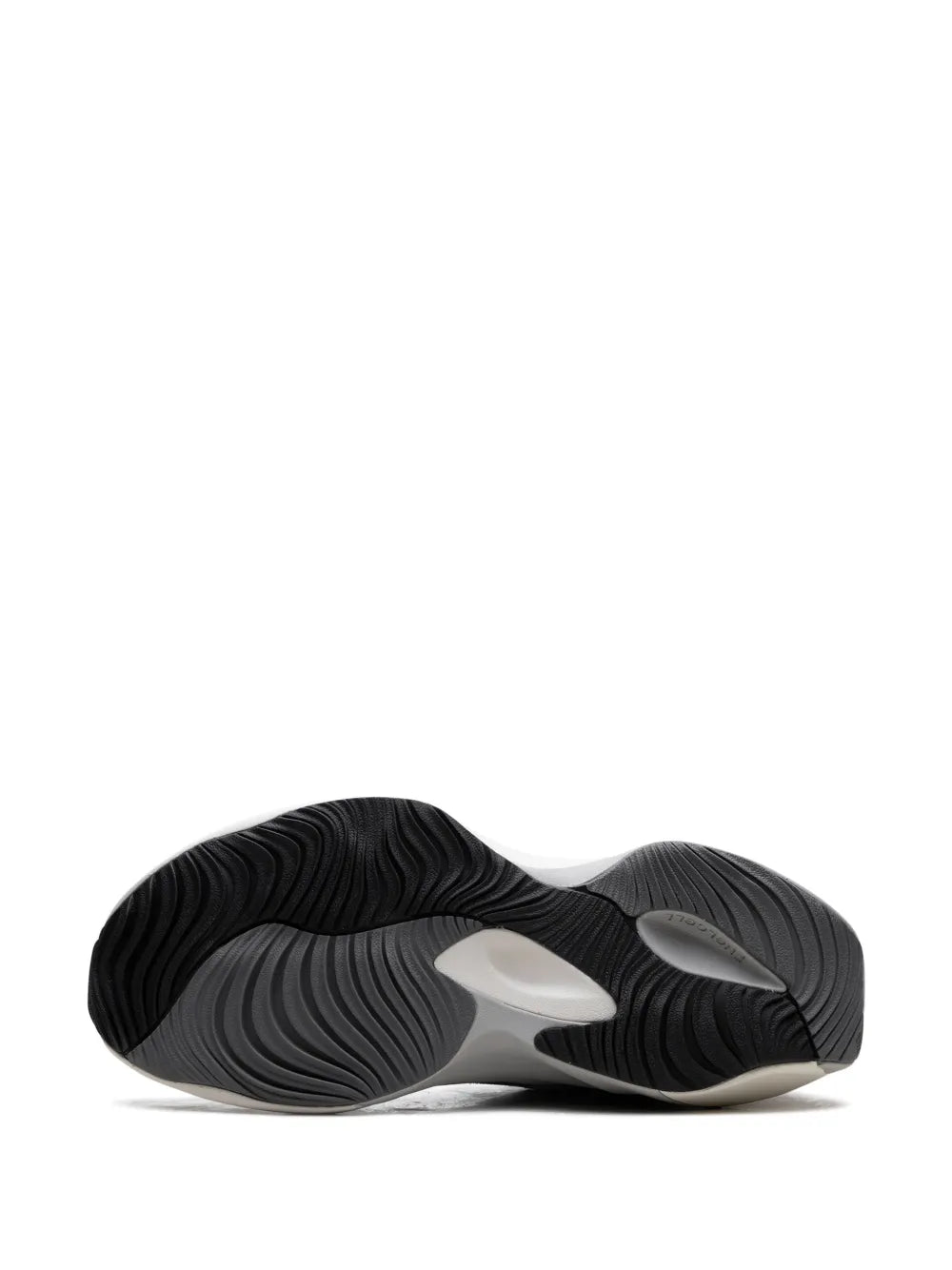 Grey running shoe outsole view with black tread pattern and white midfoot support