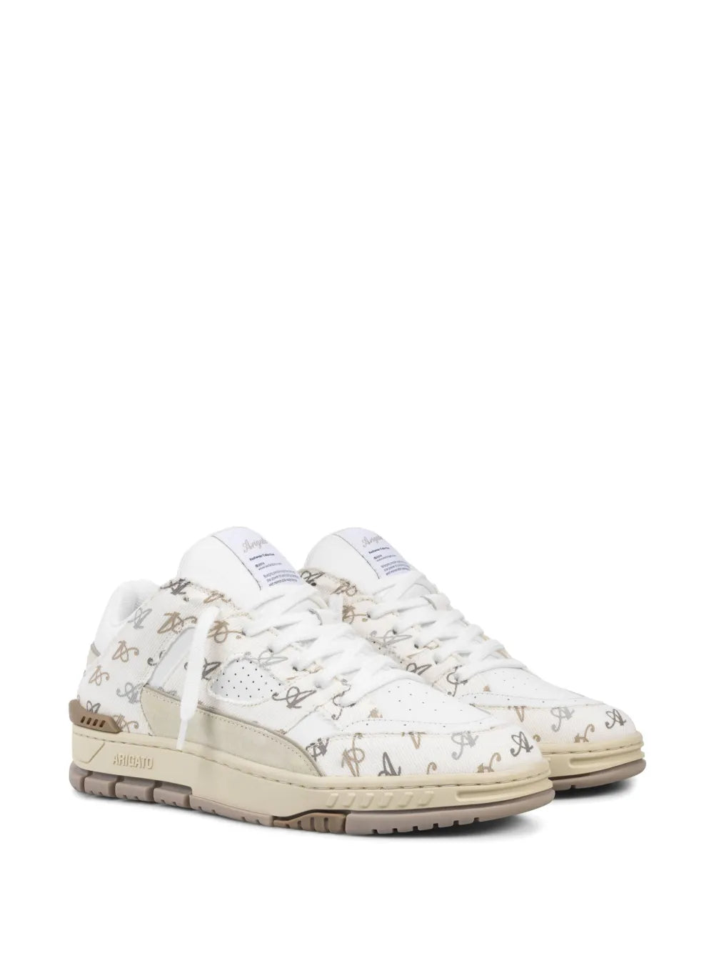 Axel Arigato monogram low-top sneakers, white laces, beige trim, rubber sole.