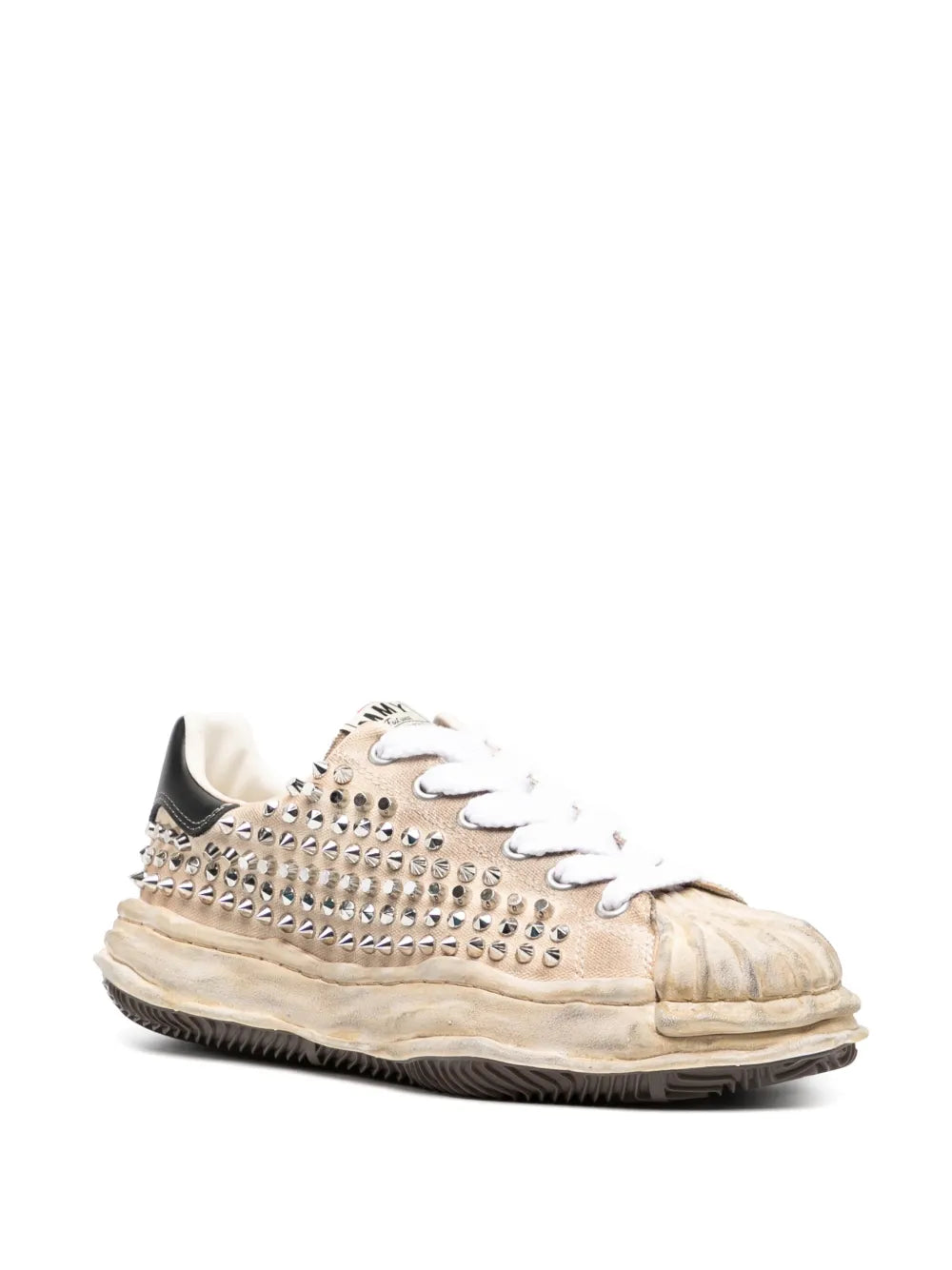 Beige canvas sneakers with silver studded side, white laces, textured dark sole