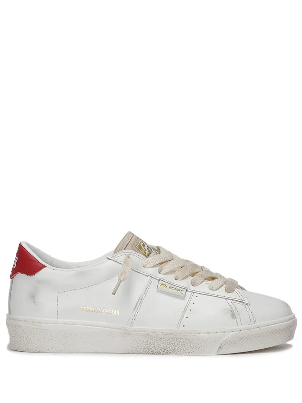 White low-top sneaker with tan laces and red heel tab, distressed rubber sole