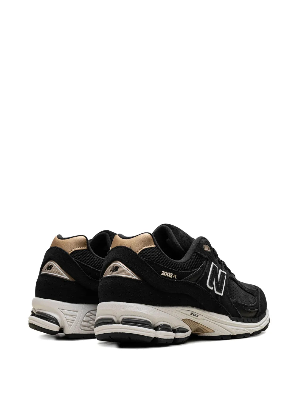Black New Balance 2002R sneakers, heel and side view with tan collar panels