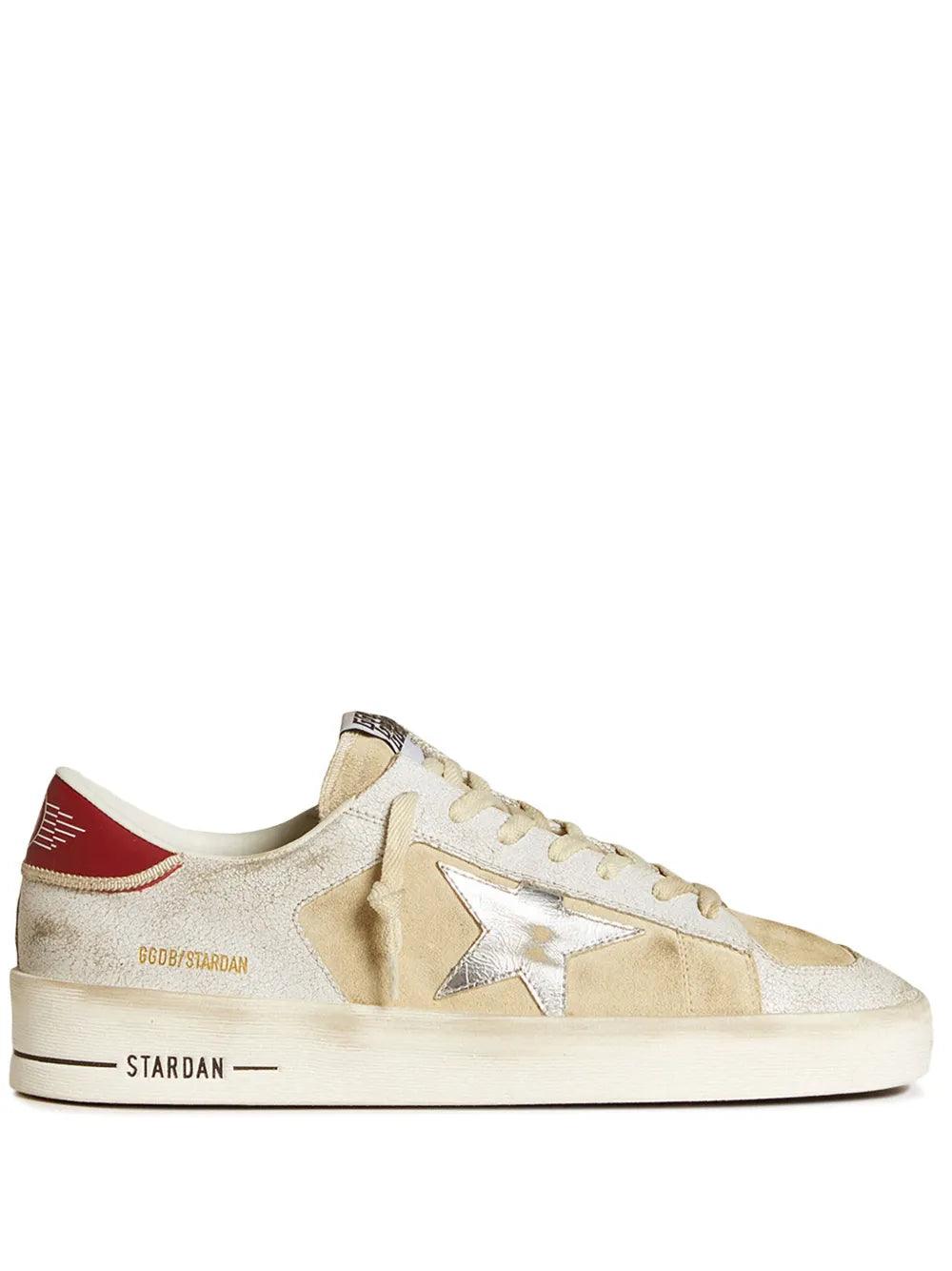 Beige suede sneakers with metallic star logo, white laces, red heel accent