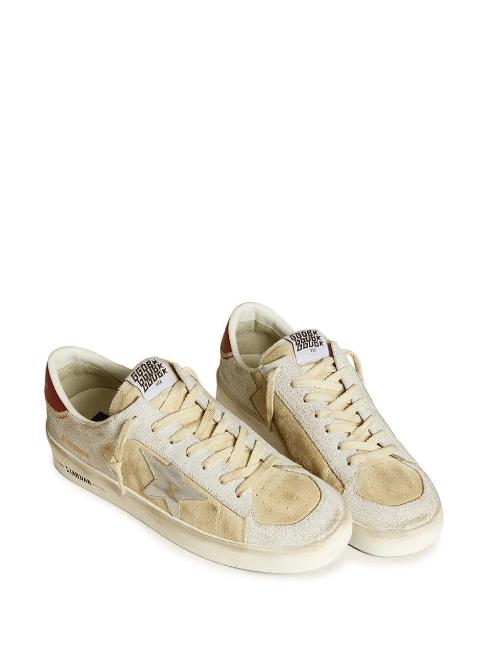 Beige and white sneakers with lace-up front and red collar, metallic star detail