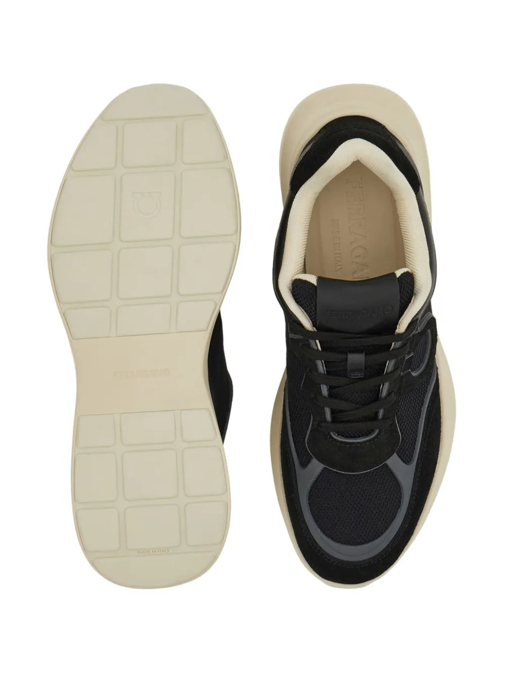 Black lace-up sneakers with cream outsole and padded collar.
