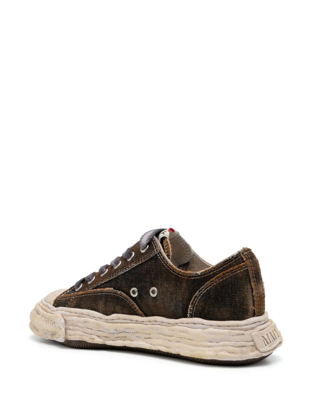Low-top sneaker side view, dark suede with metal eyelets and cream sole