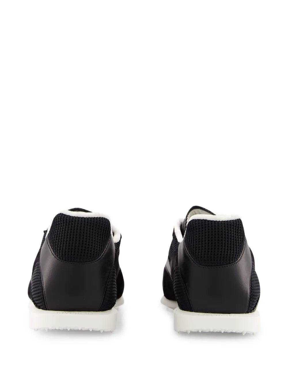 Givenchy logo sneakers, black back view with white edge sole and padded heel