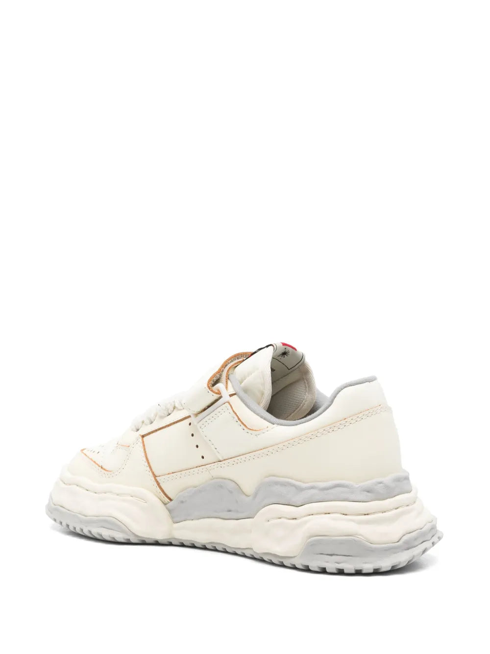 White sneakers with tan trim and heel pull tab, padded collar, chunky sole