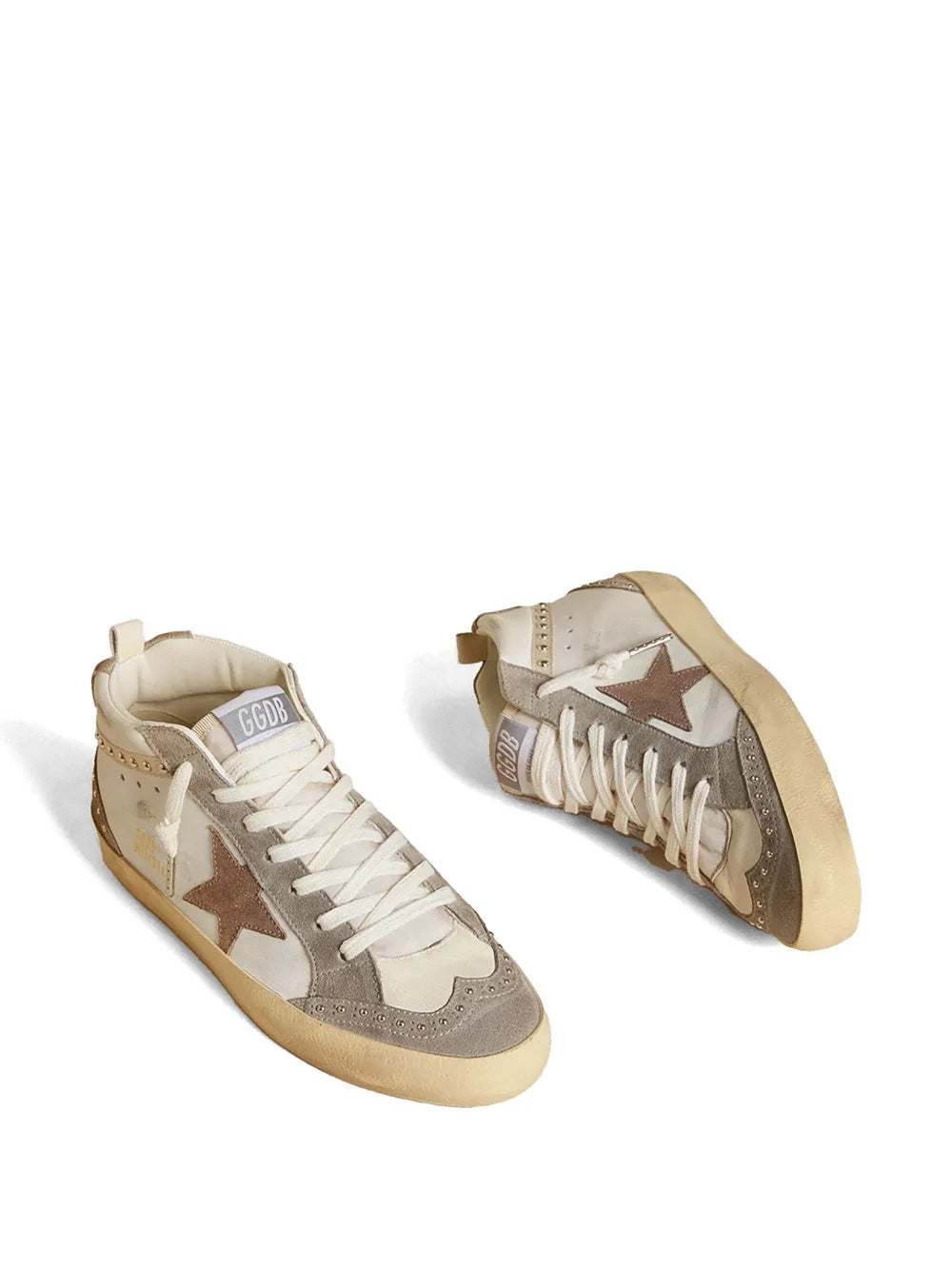 Pair of mid-top sneakers, white laces, gray and tan panels, star side details