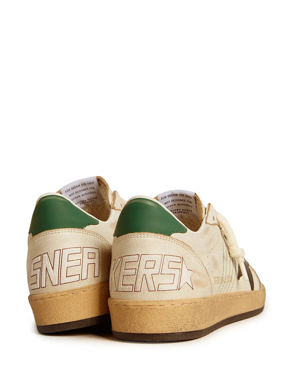 Back view sneakers in cream and tan with bold lettering, black accents and green lining