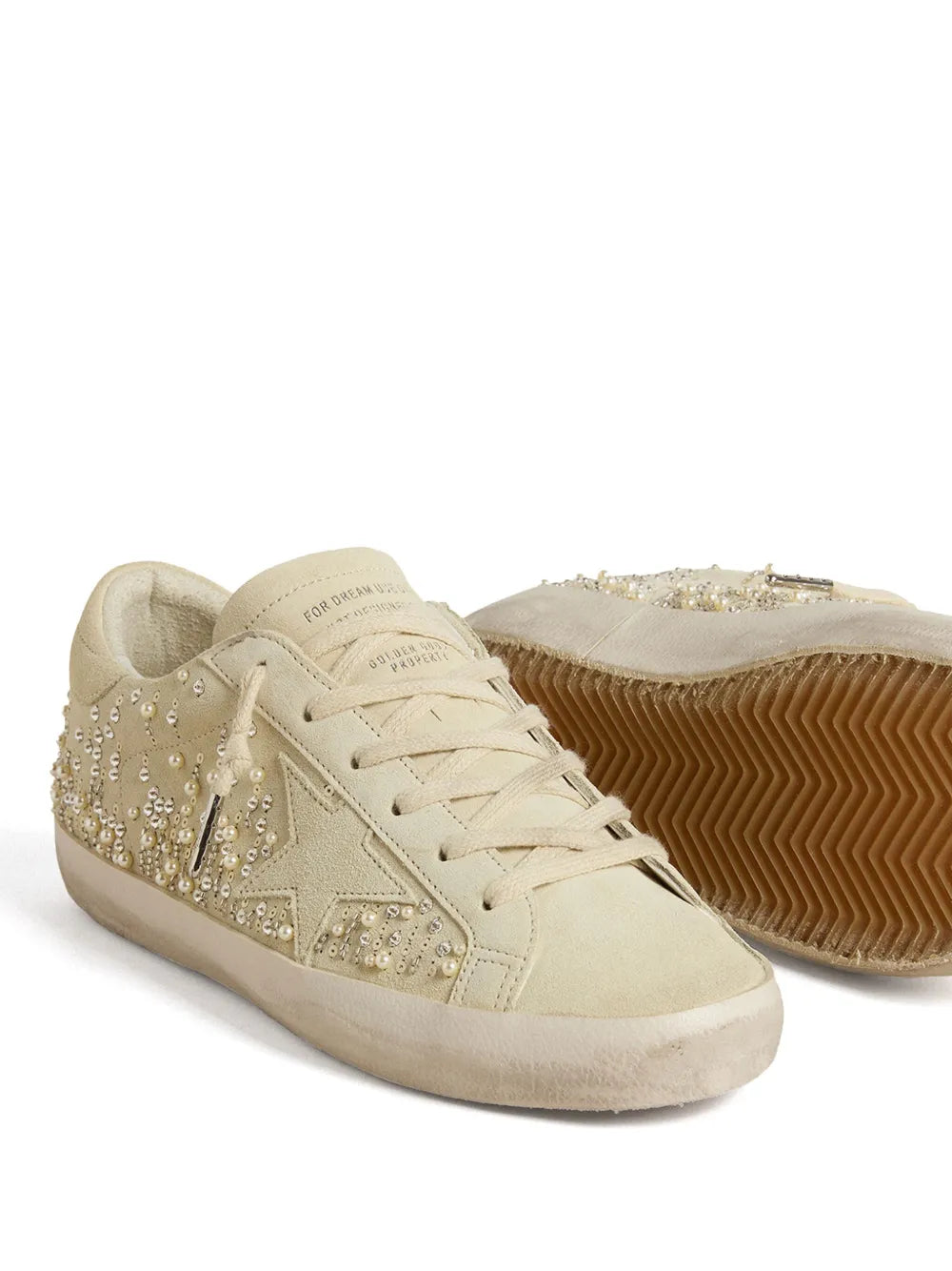 Beige lace-up sneakers with rhinestone side details and textured rubber sole