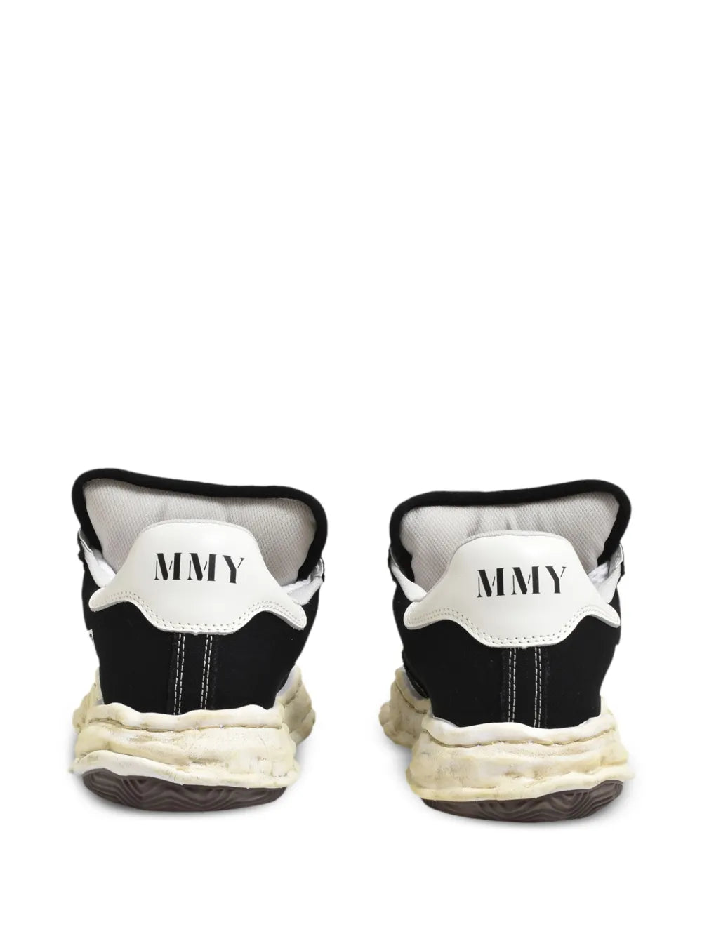 Black heel of low-top trainers with white collar lining and MMY logo patch