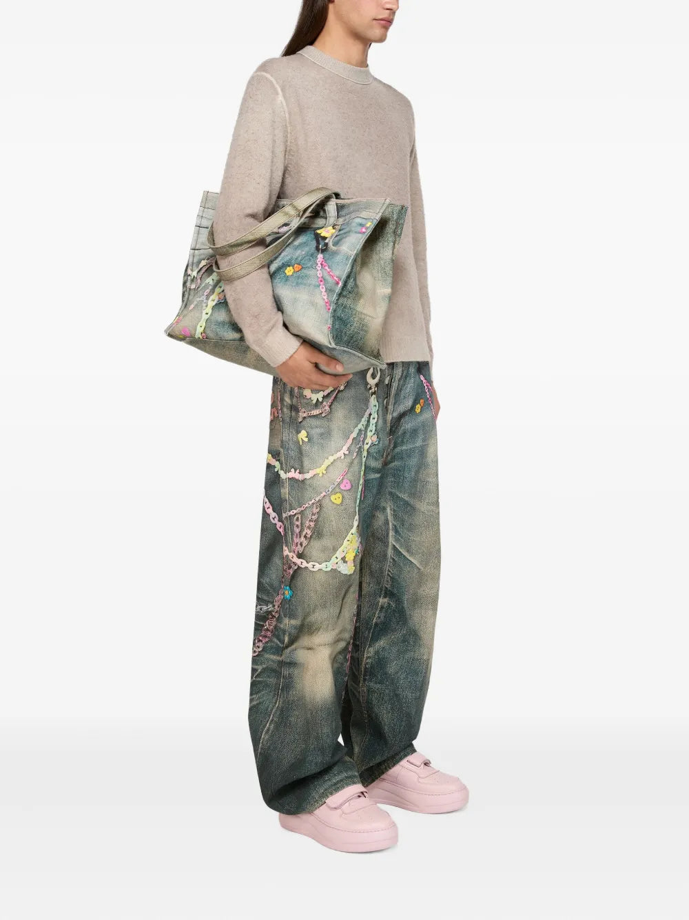 Pink platform sneakers worn with denim overalls and tote bag