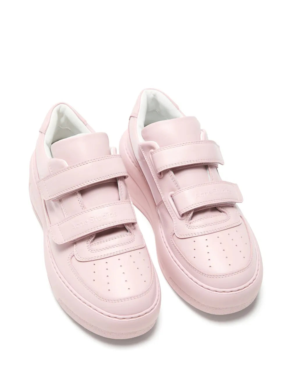 Pair of pink platform sneakers with two hook-and-loop straps, low top profile