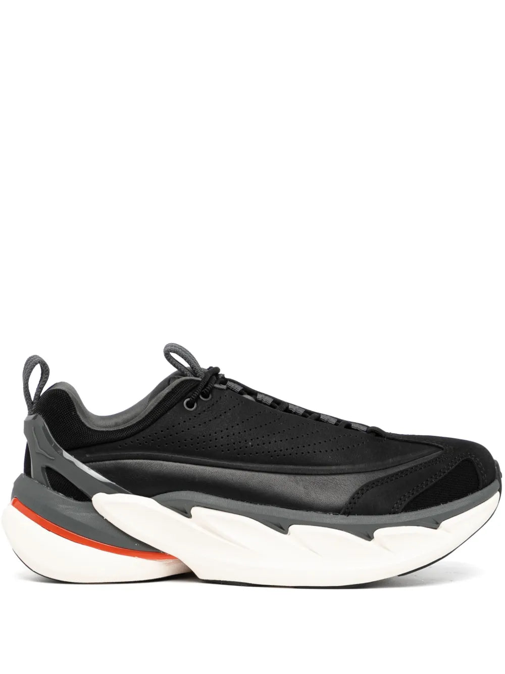 Black lace-up low-top sneakers with white midsole and orange accent stripe