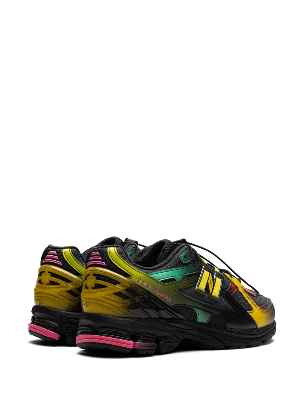 New Balance sneakers, side view with yellow overlays, green upper, pink sole trim