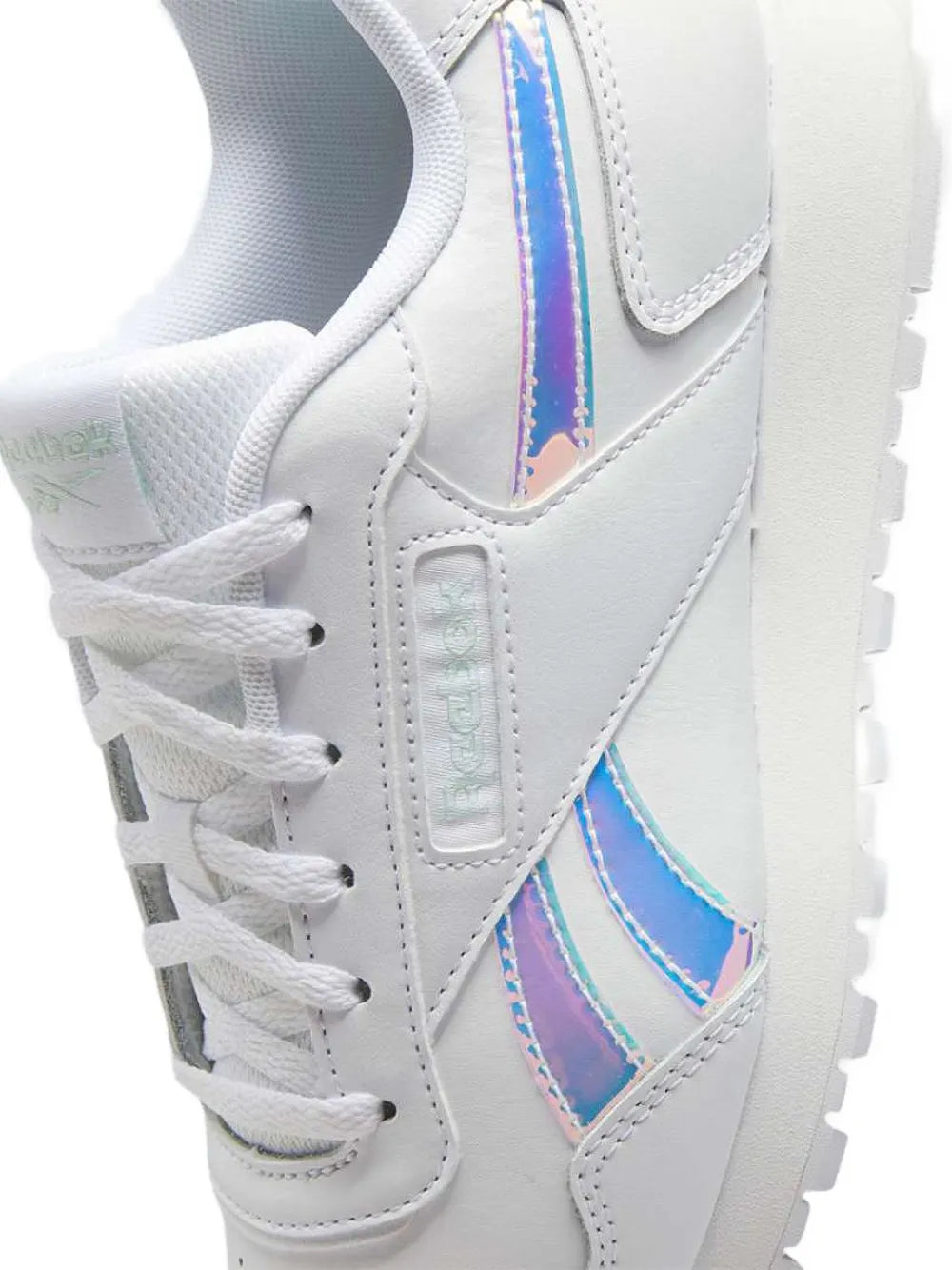 White sneaker side view with blue/purple logo panel and textured sole