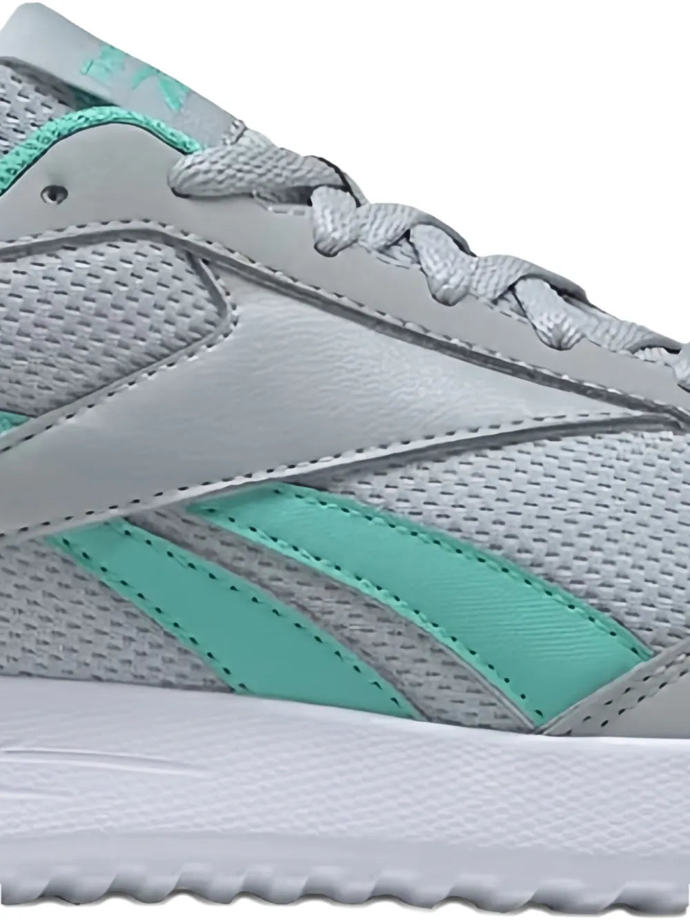 Close-up of grey low-top sneaker upper with teal stripes and lace eyelets