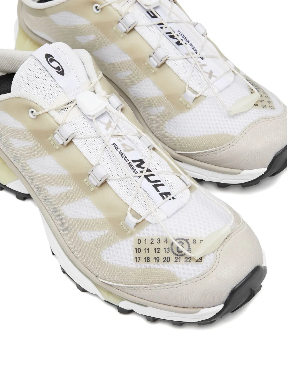 Light beige panelled sneakers with white laces, Salomon branding, textured sole