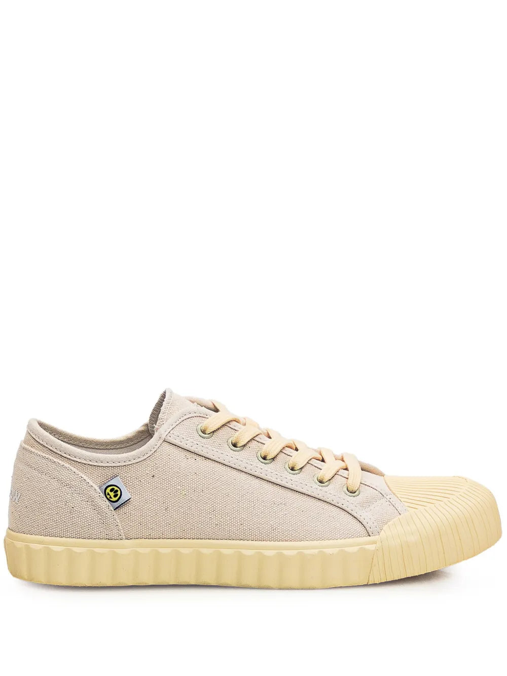 Light pink canvas trainers with lace-up front and textured gum rubber sole