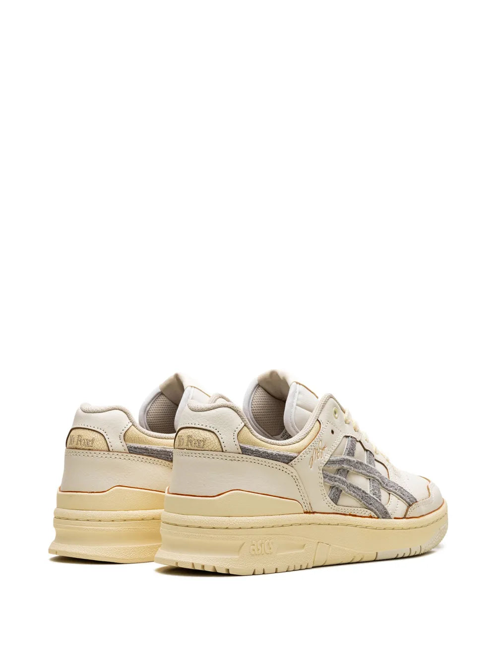 White leather low-top sneakers, heel view with gray accents and tan outsole
