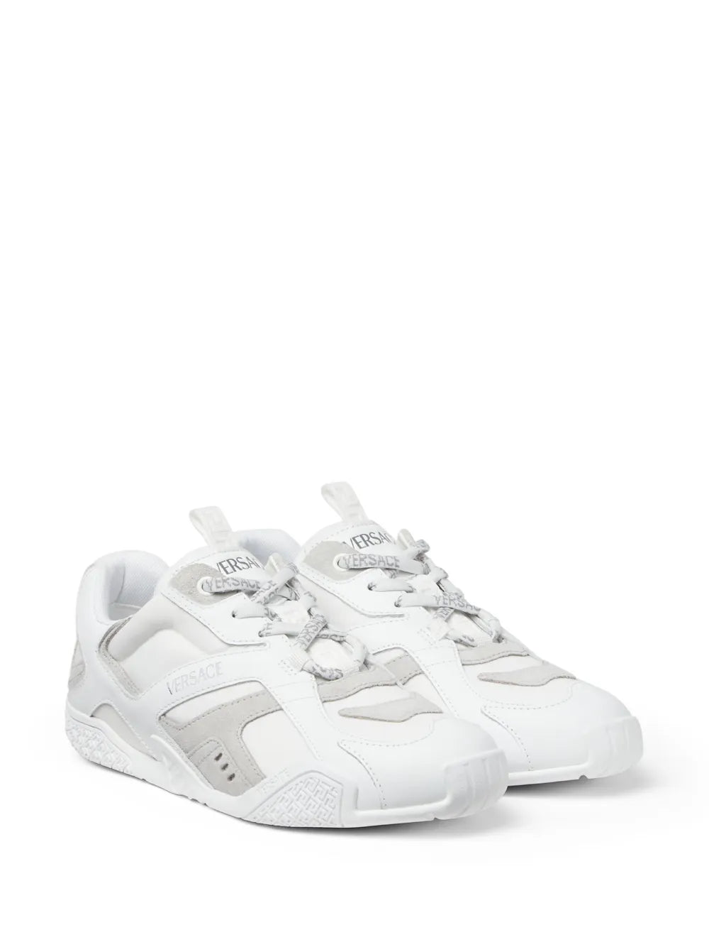 White low-top lace-up sneakers, angled side view, VERSACE logo accents and grippy sole