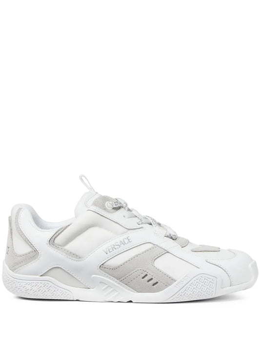 White low-top lace-up sneakers with VERSACE logo on side and chunky rubber sole