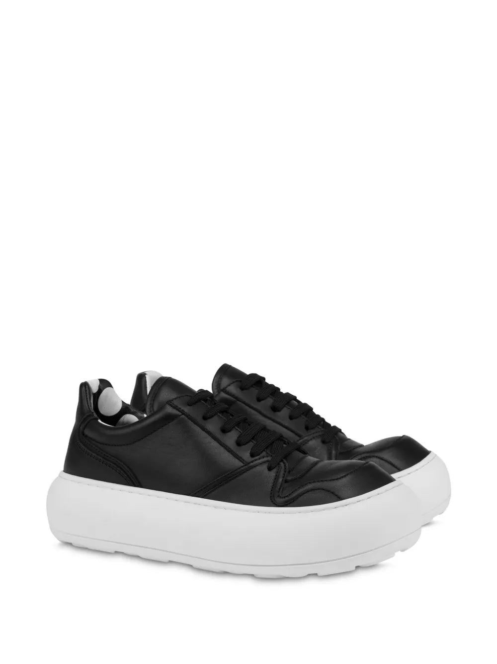 Black leather sneakers with white sole, lace-up design, side profile