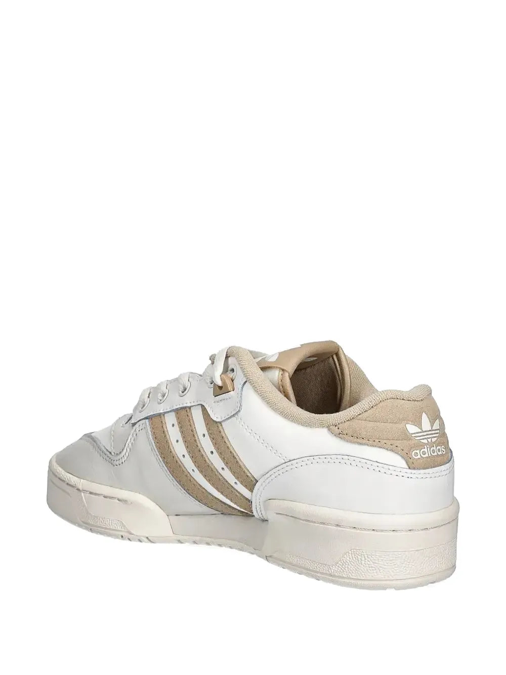 White adidas Rivalry sneakers with beige trim, heel tab, and side stripes