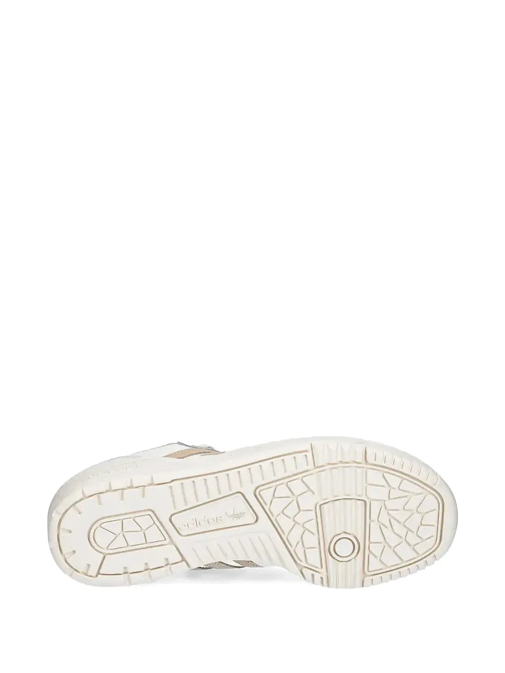 Shoe outsole with tread pattern and beige heel detail on white adidas sneakers
