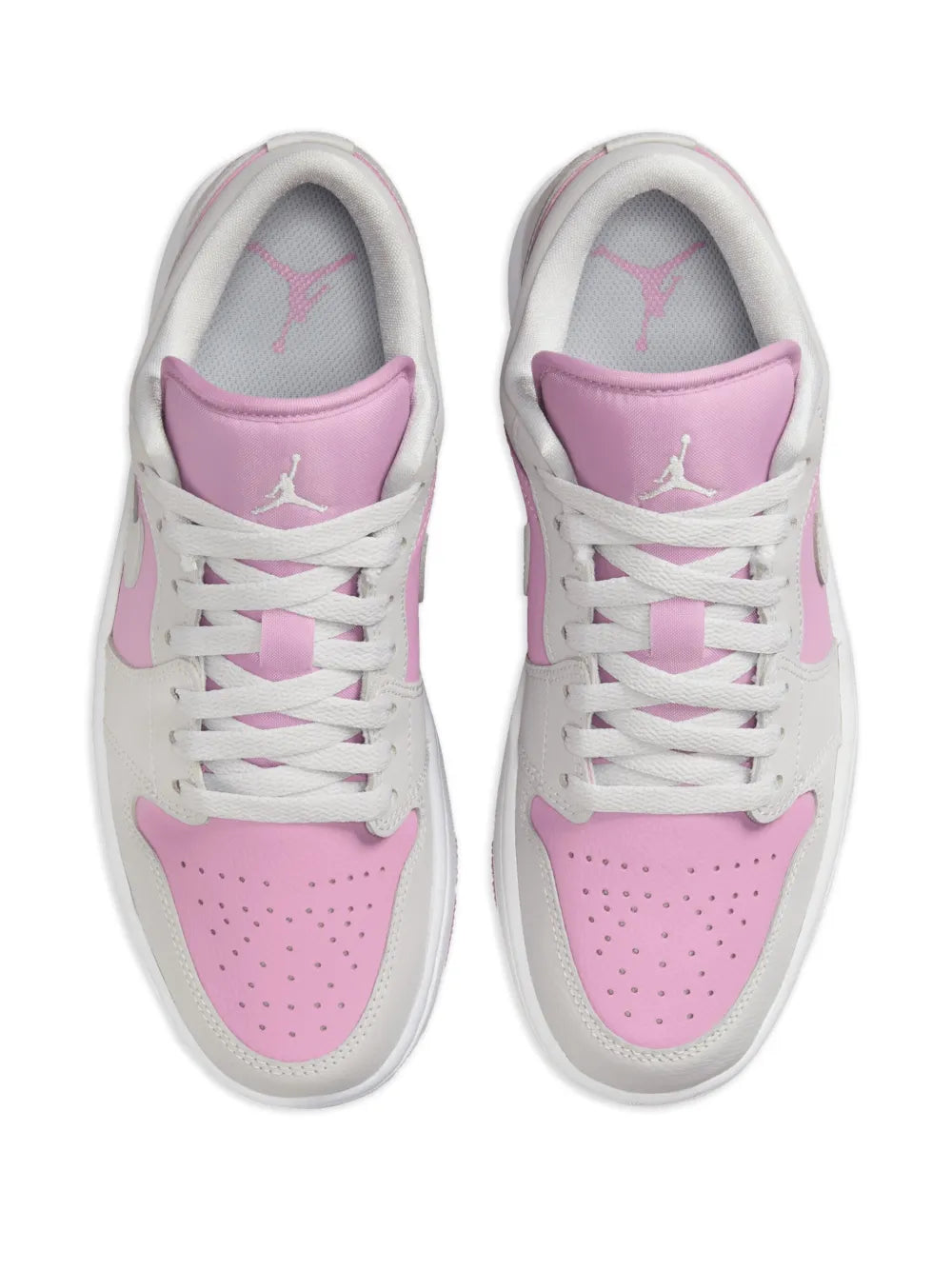 Pair of white and pink lace-up sneakers with padded tongue and Jumpman logo
