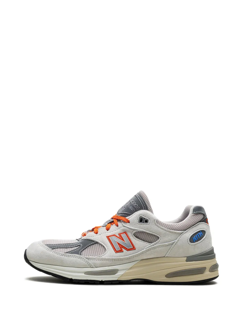 Light grey New Balance 991V2 sneakers, front side view with orange lace loops
