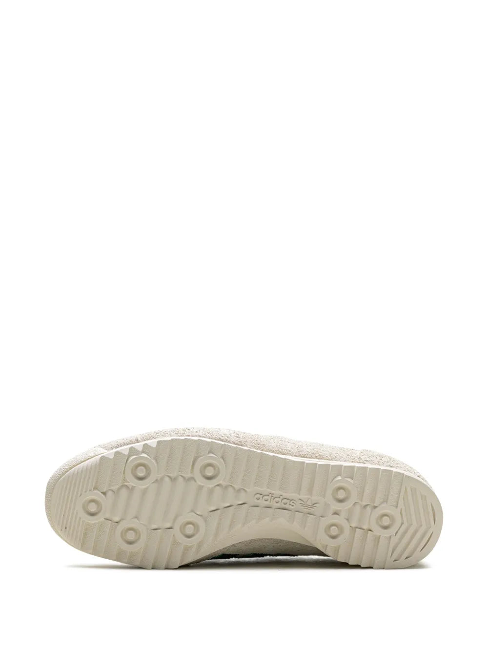 Off-white sneaker outsole tread with circular studs and adidas branding
