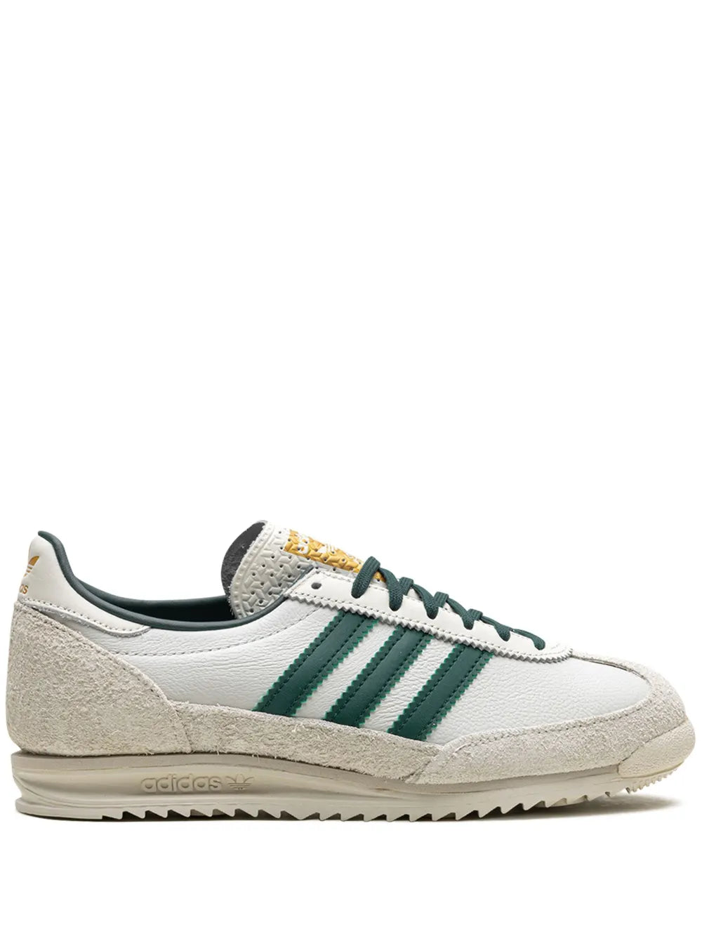 Off-white low-top adidas sneakers with green three-stripe panels and lace-up design